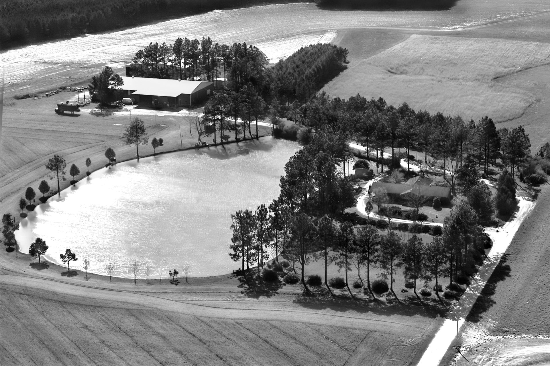 Aerial photo of the Carl Wenger farm, pond and shop in Walnut Hill, Florida, 1998